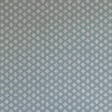 Detail of wallpaper in a minimalist quatrefoil pattern in gray on a blue field.