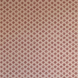 Detail of wallpaper in a minimalist quatrefoil pattern in red on a cream field.
