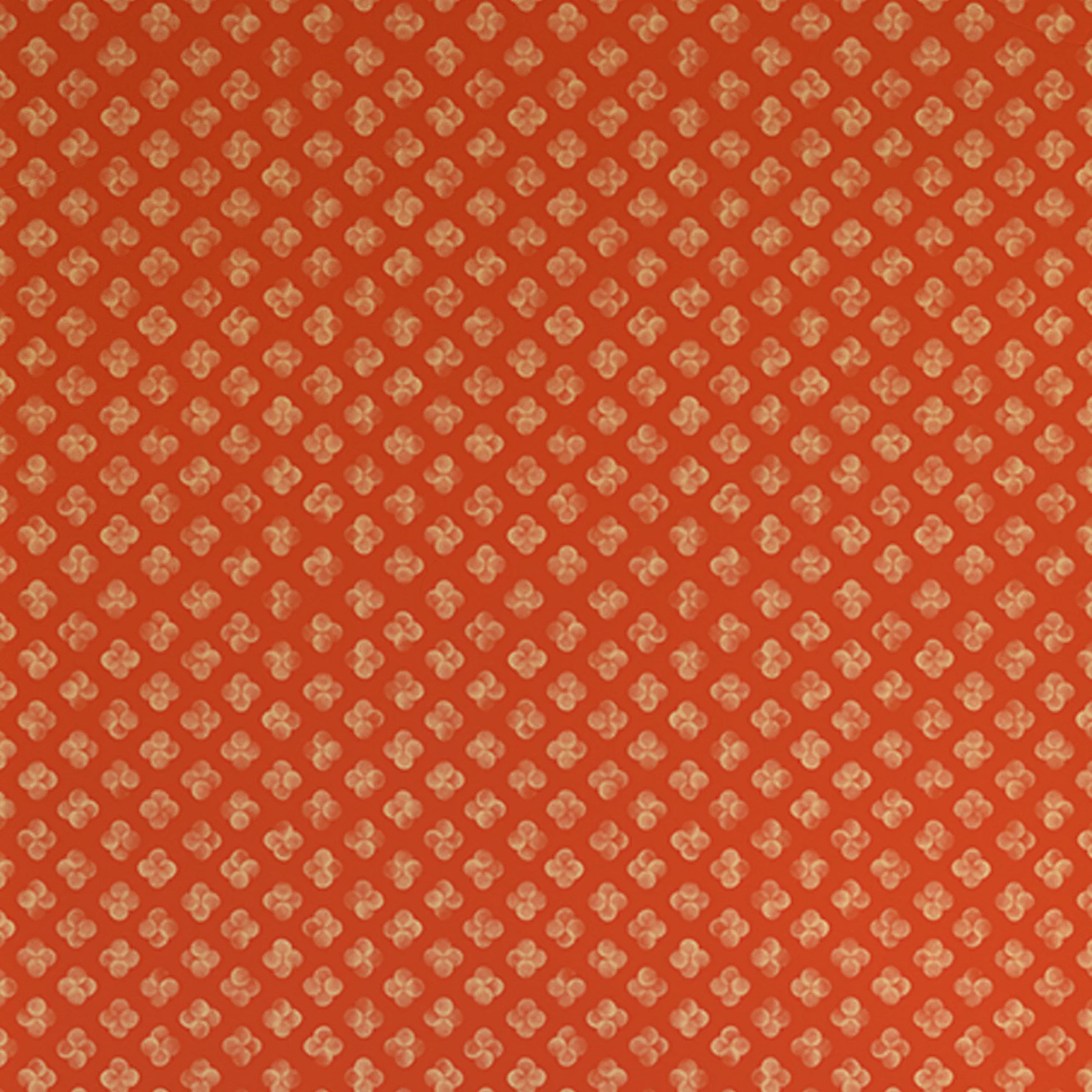 Detail of wallpaper in a minimalist quatrefoil pattern in yellow on a red field.