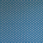 Detail of wallpaper in a minimalist quatrefoil pattern in light pink on a blue field.