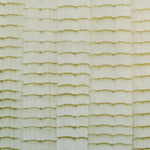 Detail of wallpaper in an abstract textural pattern in metallic green and greige.