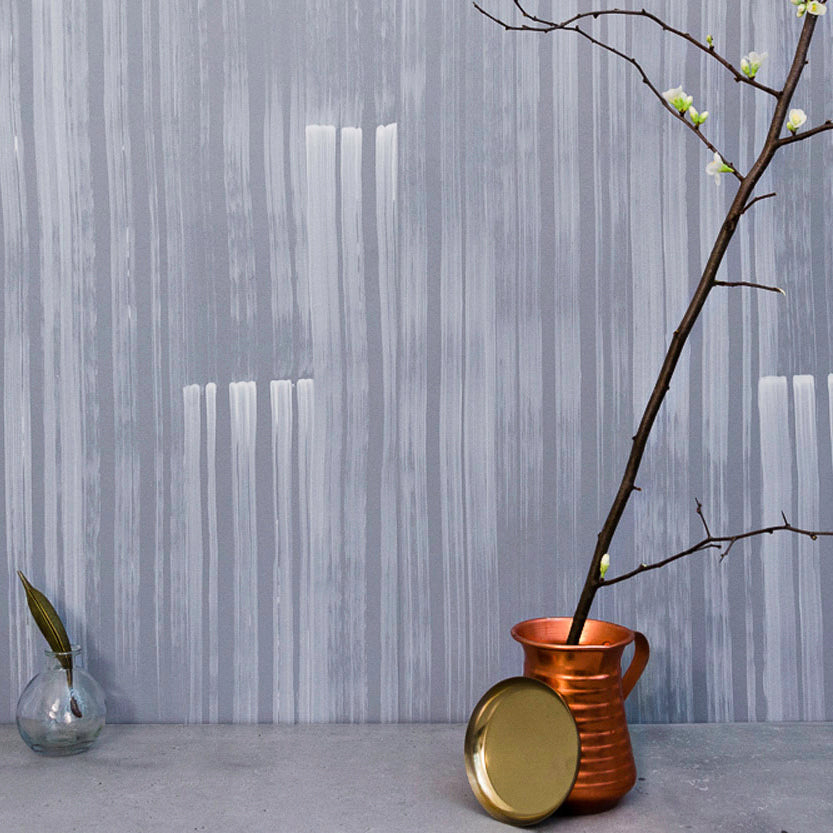 Detail of wallpaper in a muted stripe pattern in blue on a green field.