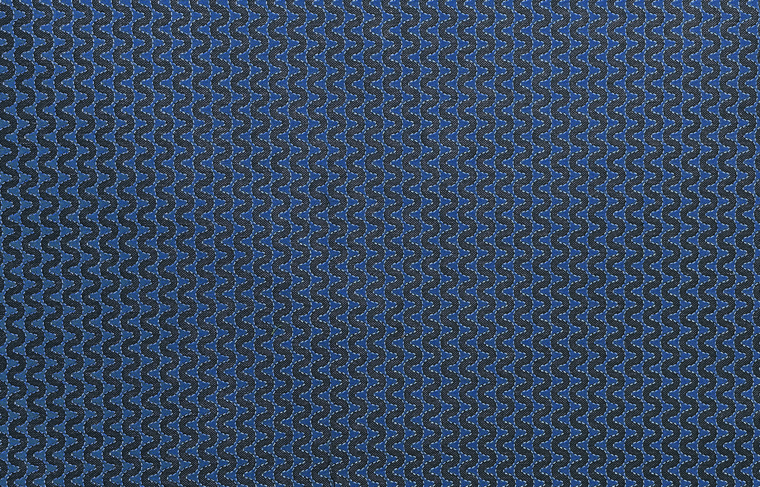 Detail of fabric in a playful curving stripe in gray on a navy field.