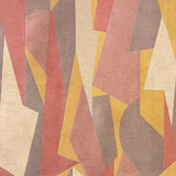 Detail of fabric in an abstract geometric print in pink, yellow, tan and brown.