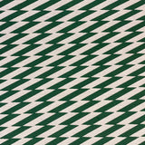 Detail of fabric in a zigzag stripe print in dark green on a cream field.