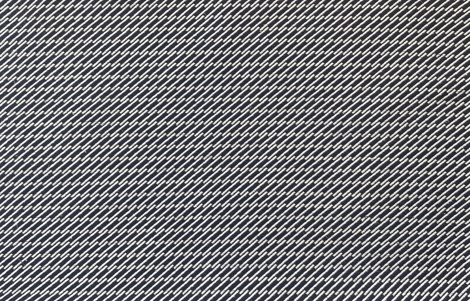 Detail of fabric in a matchstick grid print in white on a navy field.