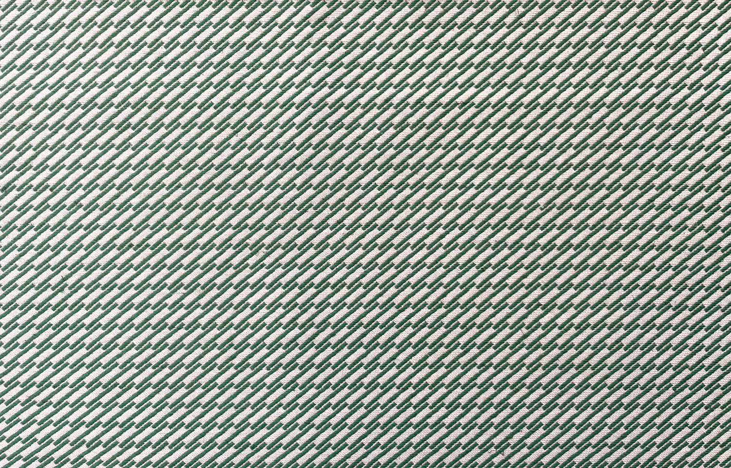 Detail of fabric in a matchstick grid print in green on a white field.