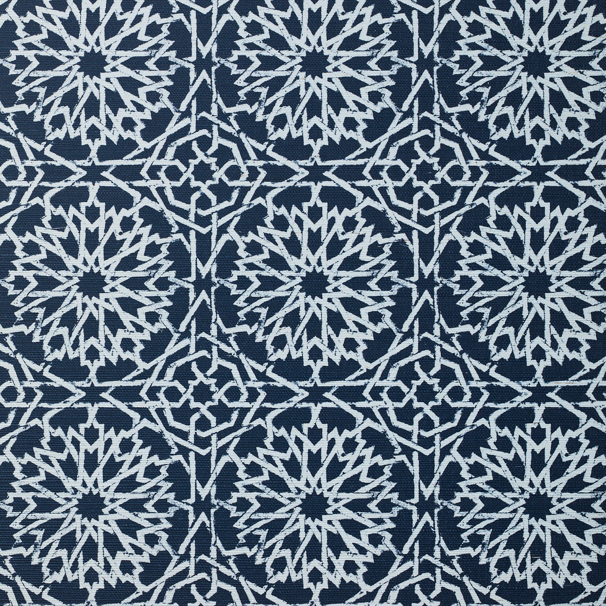 Detail of fabric in a small-scale lattice print in white on an indigo field.