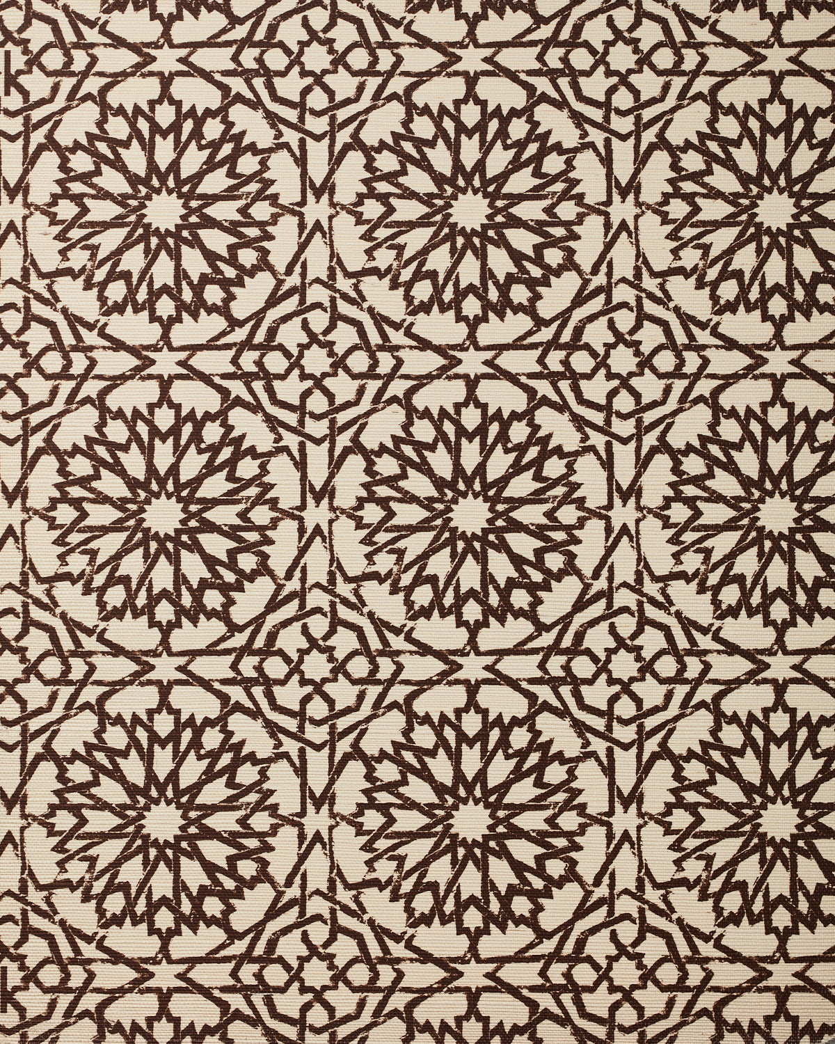 Detail of fabric in a small-scale lattice print in brown on a cream field.