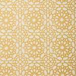 Detail of fabric in a small-scale lattice print in yellow on a cream field.