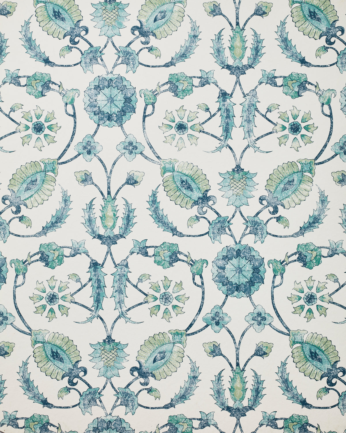 Detail of wallpaper in a floral paisley print in shades of navy and green on a cream field.