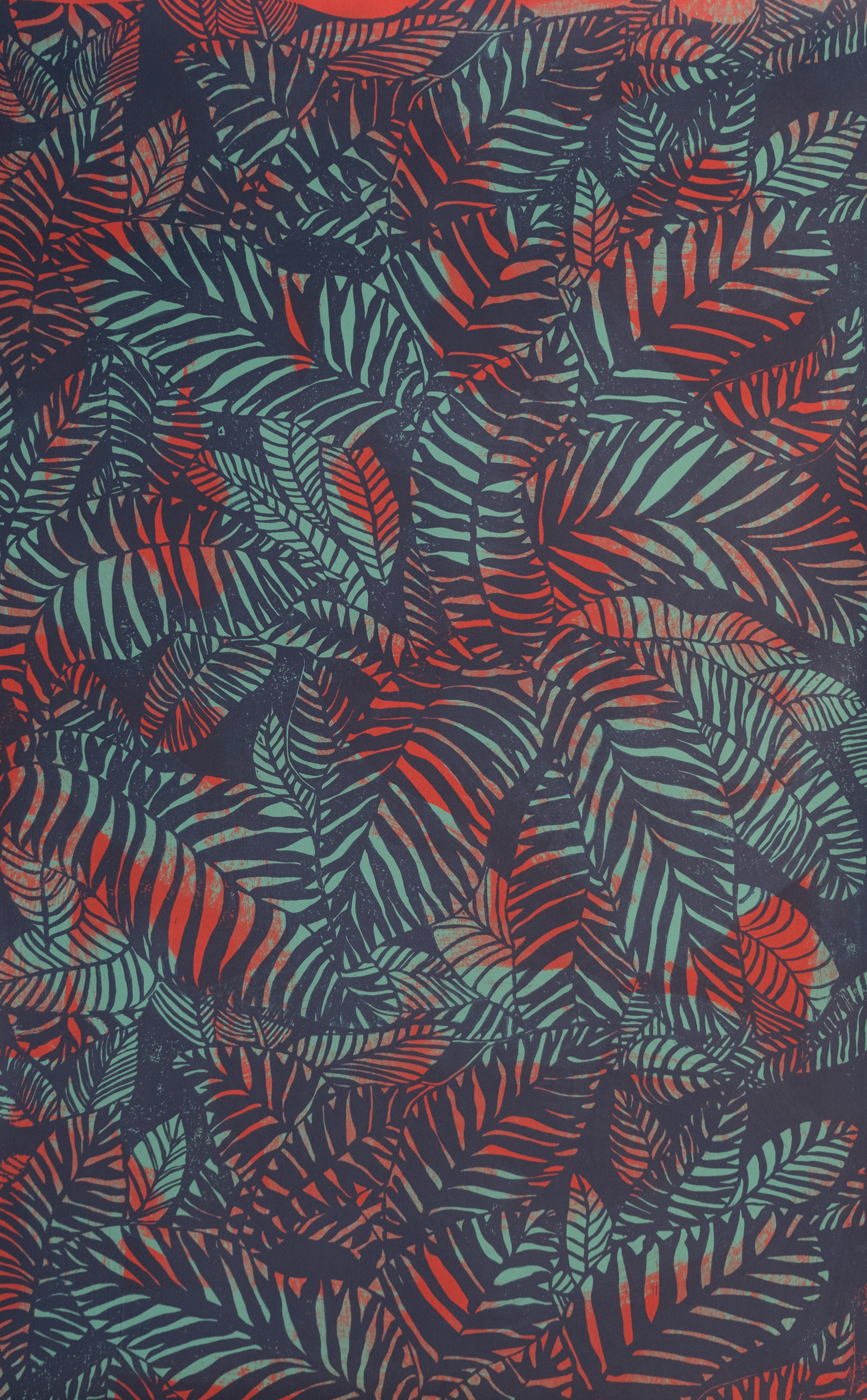 Detail of wallpaper in a dense leaf print in red and turquoise on a purple field.