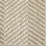 Close up of a woven herringbone design carpet in beige.