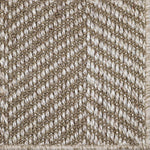 Close up of a woven herringbone design carpet in ecru.
