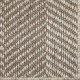 Close up of a woven herringbone design carpet in ecru.