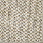 Close-up of a textured sisal carpet in natural.