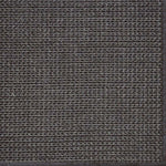 Close-up of a textured woven performance carpet in dark brown.
