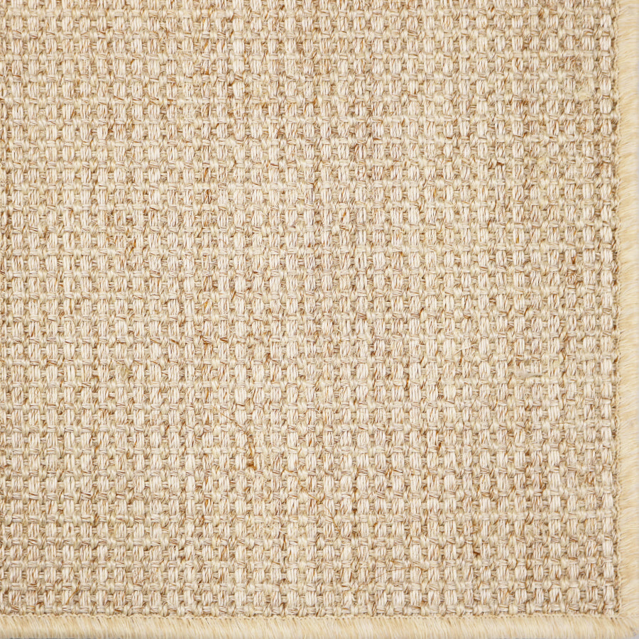 Close-up of a textured woven performance carpet in beige.