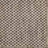 Close-up of a textured woven broadloom in natural with black warp.
