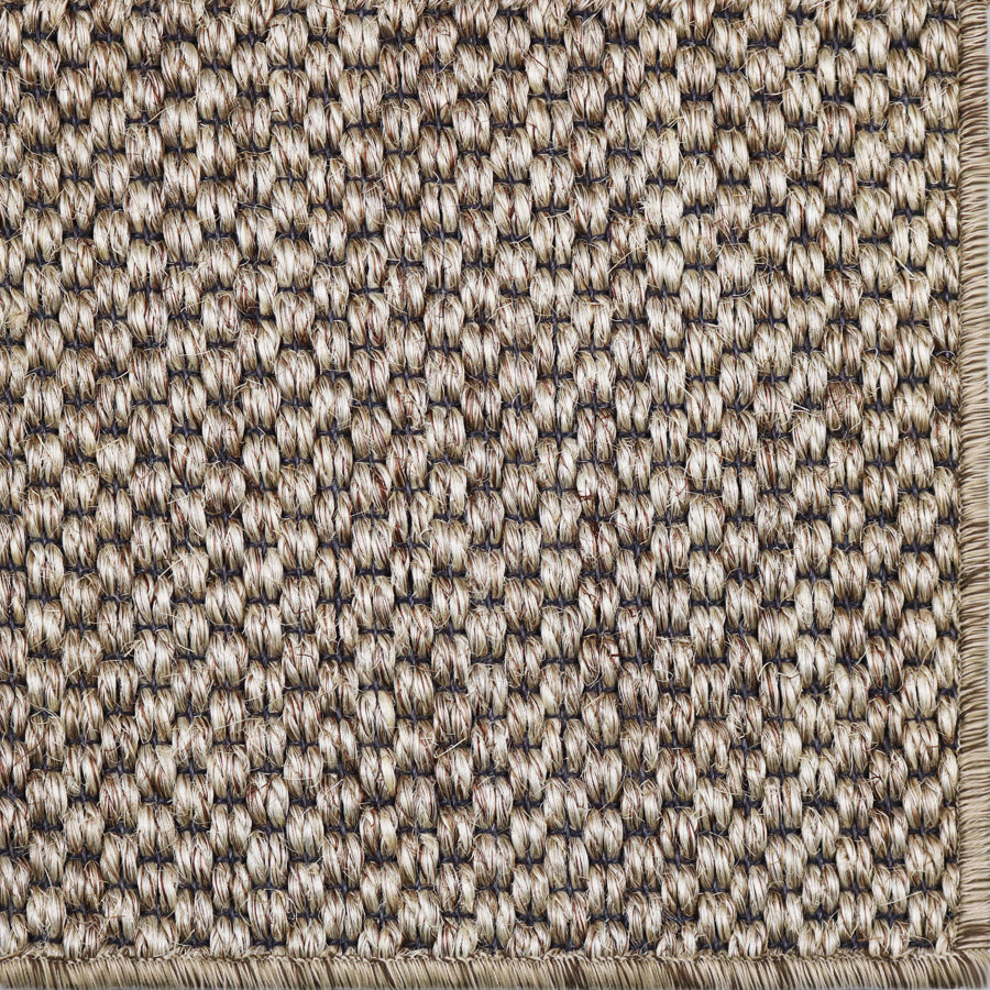 Close-up of a textured woven broadloom in natural with black warp.