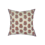 Throw pillow with printed and embroidered floral pattern in coral and purple on white.