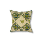 Throw pillow with printed and embroidered design in a floral medallion in blue and green. 