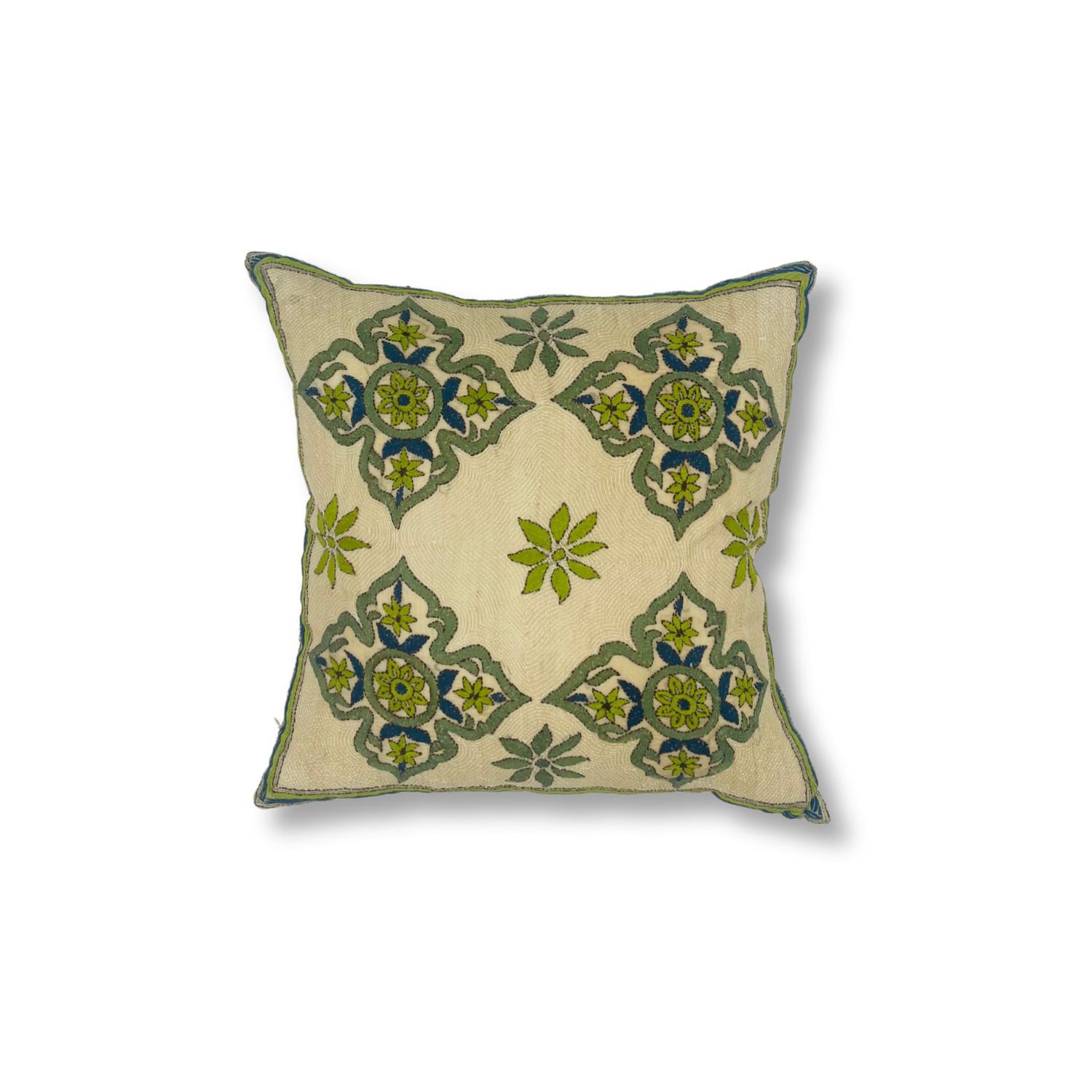 Throw pillow with printed and embroidered design in a floral medallion in blue and green. 
