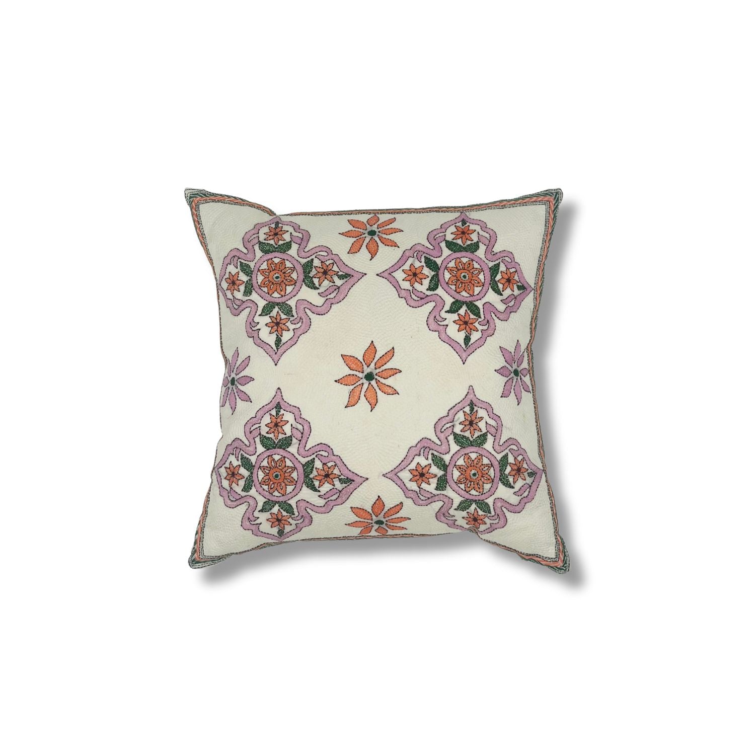 Throw pillow with printed and embroidered design in a floral medallion in pink orange and green. 