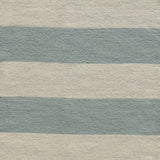 Handwoven rug with wide stripes in cream and light blue. 