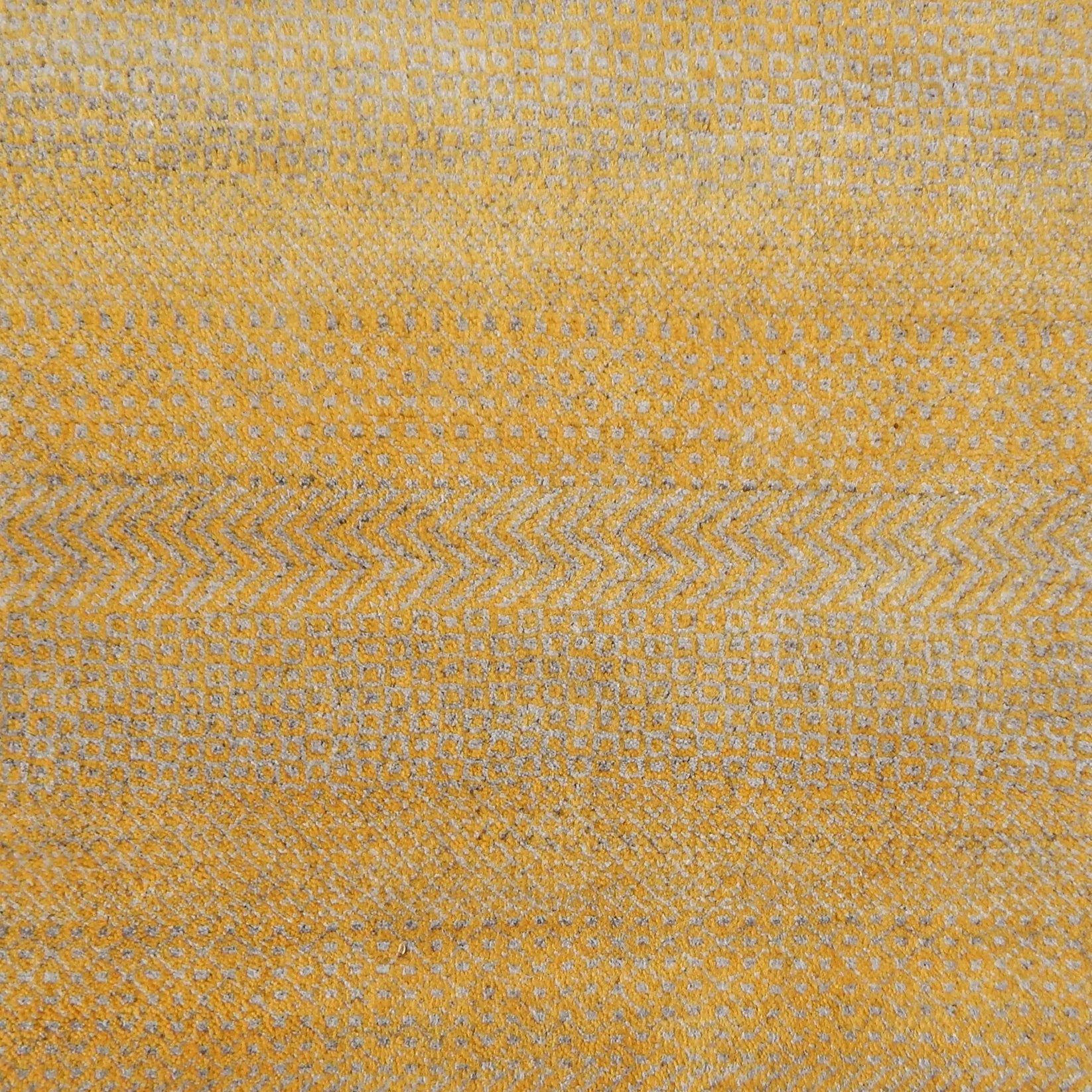 Handknotted rug with small scale geometric pattern in yellow and beige. 