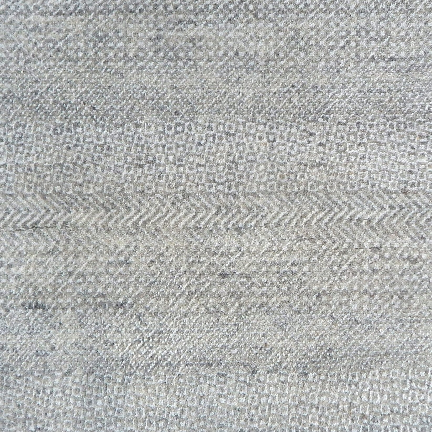 Handknotted rug with small scale geometric pattern in light grey.