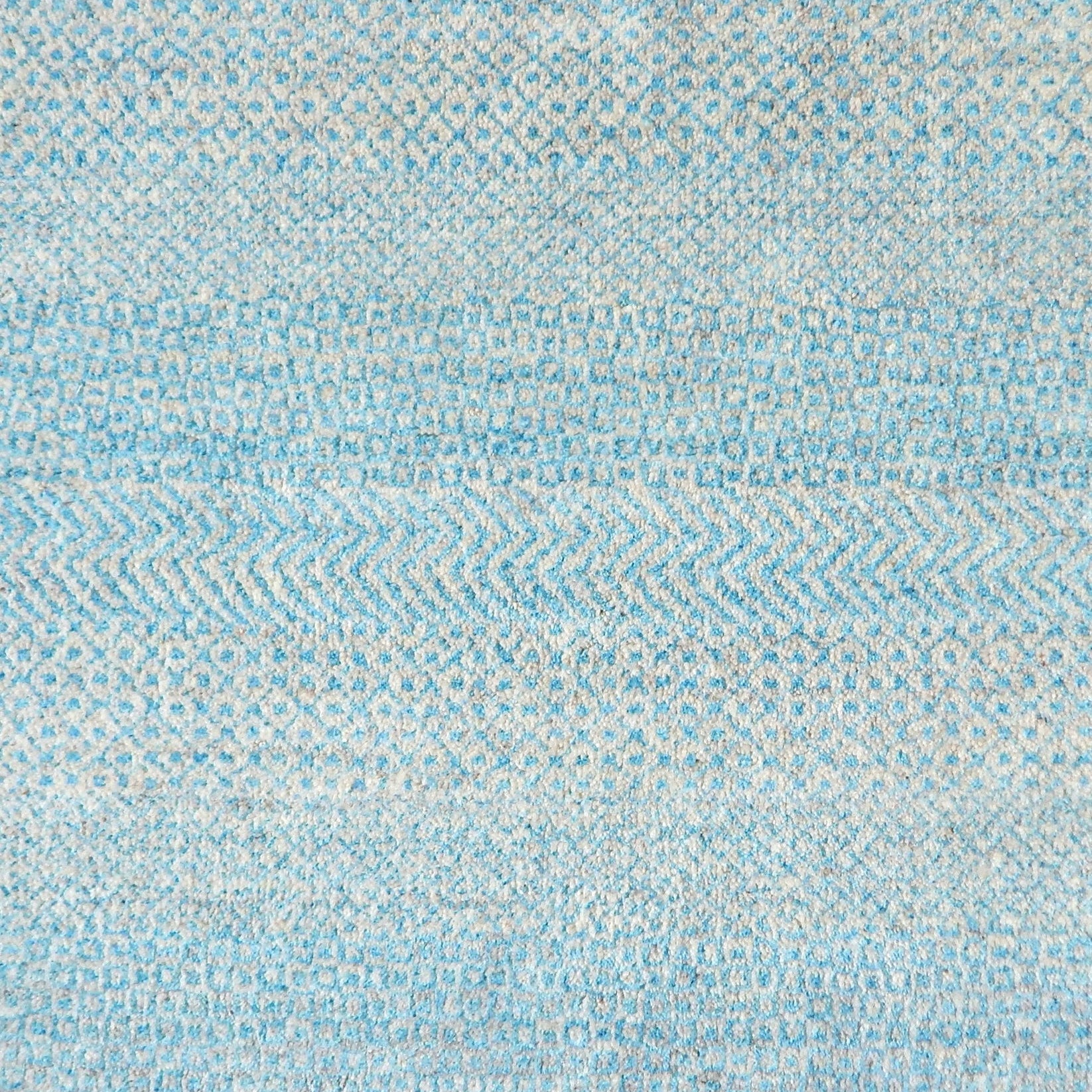 Handknotted rug with small scale geometric pattern in turquoise blue and pale grey. 