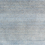 Handknotted rug with small scale geometric pattern in grey and blue. 