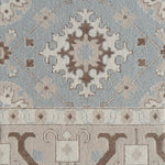Decorative rug with intricate pattern in blue and brown. 