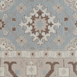 Decorative rug with intricate pattern in blue and brown. 