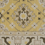 Close-up of a patterned rug with geometric design on a yellow background