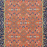 Decorative rug with intricate pattern on a red and blue background