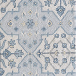 Patterned rug with blue and cream ornate geometric design
