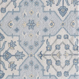 Patterned rug with blue and cream ornate geometric design