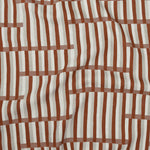 Gently draped printed linen in a broken stripe design in red, ecru, clay pink and cream. 