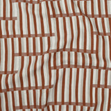 Gently draped printed linen in a broken stripe design in red, ecru, clay pink and cream. 