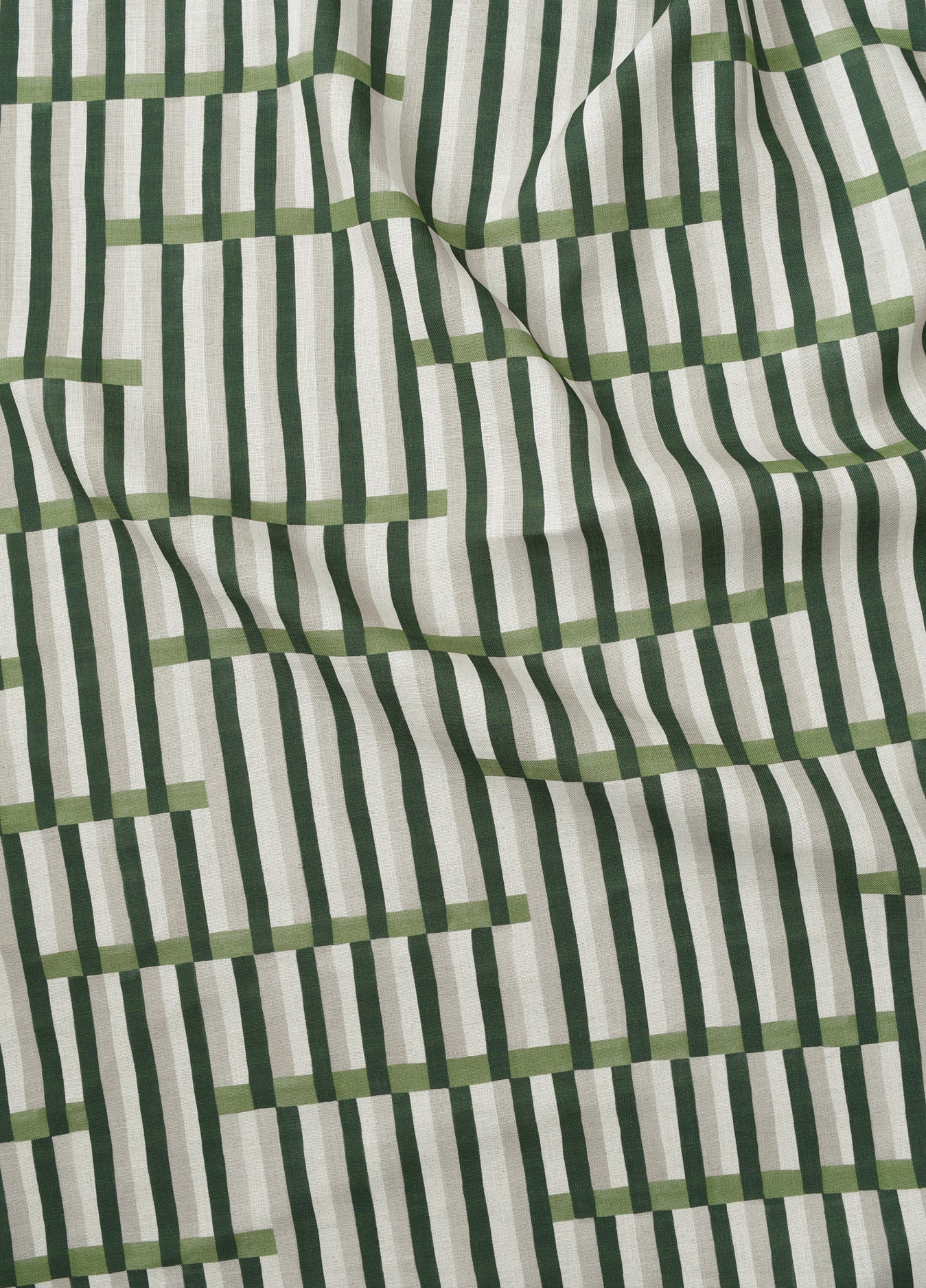 Gently draped printed linen in a broken stripe design in hunter green, sage green, ecru and cream. 