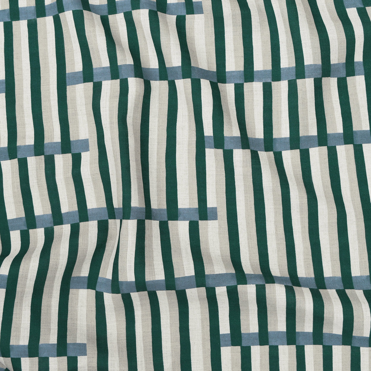 Gently draped printed linen in a broken stripe design in teal, ocean blue, ecru and cream. 