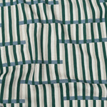 Gently draped printed linen in a broken stripe design in teal, ocean blue, ecru and cream. 