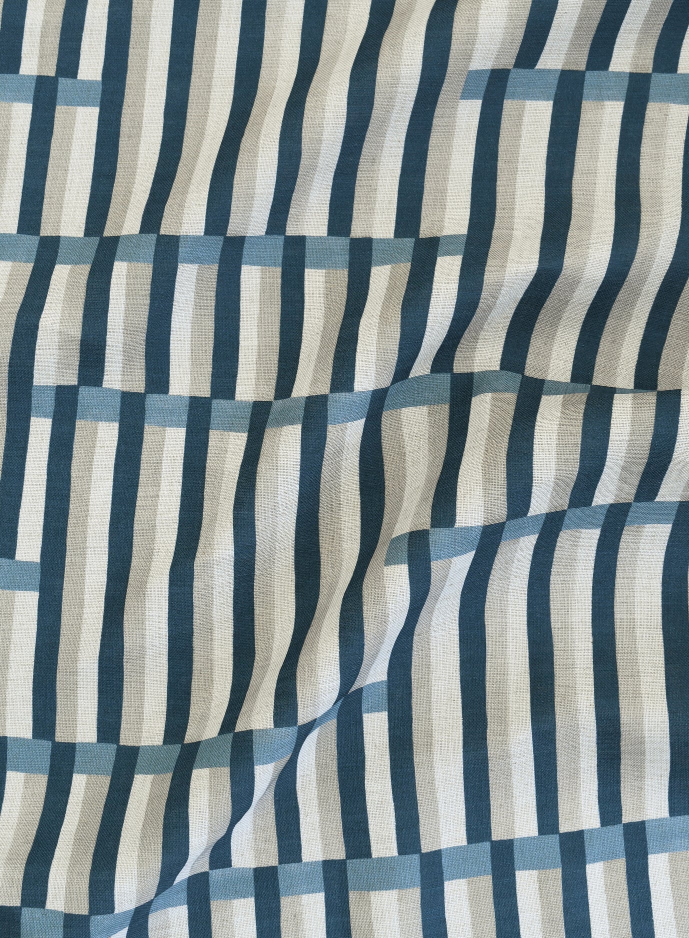 Gently draped printed linen in a broken stripe design in navy, chambray blue, ecru and cream. 