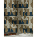 A painted box in front of a wall in a pattern of brown geometric vessel shapes over a white background with navy blue horizontal stripes.