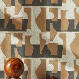 A sphere with marble base in front of a wall with a pattern of brown geometric vessel shapes over a white background with charcoal grey horizontal stripes.