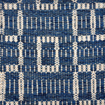 Handwoven rug sampe in with a deep blue field with a gridded square motif in ivory. 