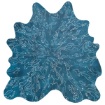 Detail of a cowhide rug in mottled blue with a white curvilinear overlay.