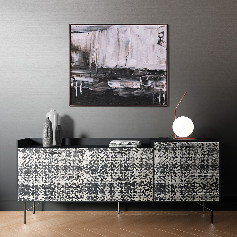 A modernist black sideboard upholstered in mottled black and white leather.